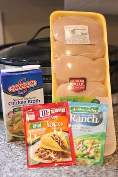 some food is sitting on the counter next to an open stove top and a bag of chicken broth