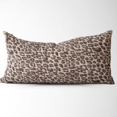 a leopard print pillow on a white background