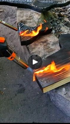 an open book is on fire and it's being used as a tool to burn wood