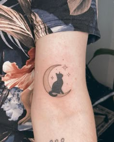 a black cat sitting on the moon tattoo