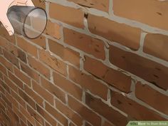 a brick wall with a hand holding a coffee cup on it's side and pointing to the right