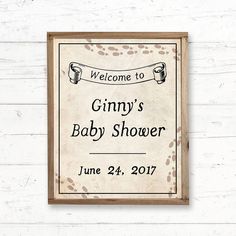 a baby shower sign hanging on the wall