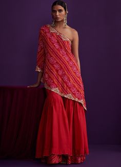 Red One Shoulder Asymmetrical Kurta Sharara Set Pink City by Sarika - Fabilicious Fashion Sharara Draping Styles, Sagan Dresses, Bandhani Dress Pattern, Red Sharara, Kurta And Sharara Set, Kurta And Sharara, Sharara Designs, Bandhani Print, Sharara Pants