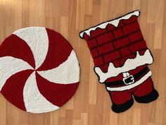 a red and white rug with santa clause on it next to a peppermink rug