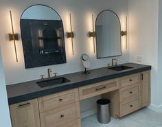 a bathroom with double sinks and mirrors on the wall