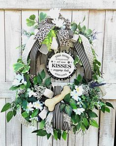 a wreath that says kiss me and has flowers on it