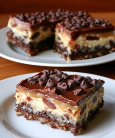 two plates with desserts on them sitting on a table