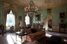 a living room filled with furniture and a chandelier