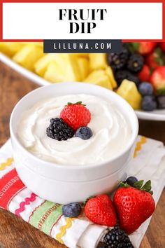 a bowl of fruit dip with berries and pineapples in the background