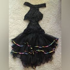 a dress made out of tulle and sequins is laying on the floor