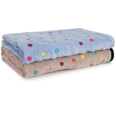 two blankets stacked on top of each other in different colors and patterns, one with polka dots