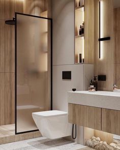 a bathroom with a toilet, sink and shower stall is shown in this image from the front view