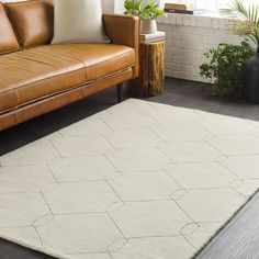 a living room with a couch, chair and rug