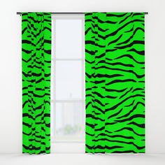 a green and black zebra print curtain hanging in front of a window