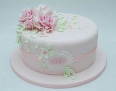 there is a pink cake with flowers on it