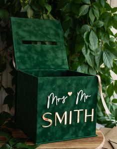 a green box with the words mrs and mr on it sitting on top of a wooden table