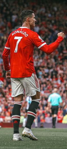 the soccer player is celebrating his team's victory over the opposing team in front of an audience