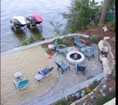 an outdoor fire pit surrounded by lawn chairs