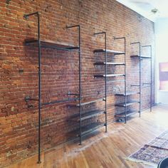 an empty room with brick walls and shelving