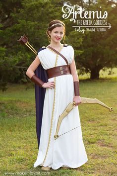 an image of a woman dressed in greek costume with bow and arrow on her head