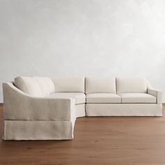 a white couch sitting on top of a hard wood floor next to a wooden floor