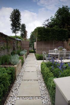 an outdoor garden with gravel paths and plants