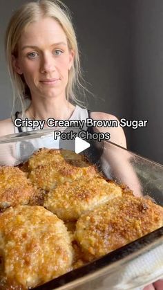 a woman holding a pan full of food in front of her with the caption crispy creamy brown sugar pork chops