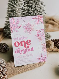 there is a card with the words winter onederland on it next to pine cones