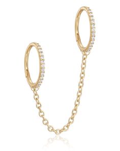 a pair of gold hoop earrings with white stones on the side and a chain around it