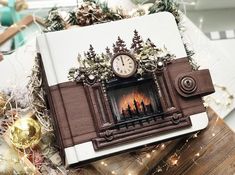 there is a book with a clock on it and christmas decorations around the bookshelf