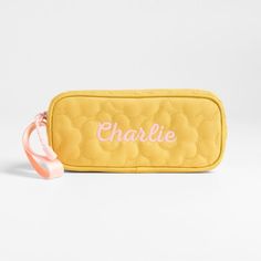 A fun pencil case that's built to handle all the thrills of the day. A pattern of quilted blooms add sunny vibes to the yellow exterior, and the contrasting pink zipper, zipper pull and loop handle give it the perfect finish. Constructed of supremely durable polyester fabric that includes recycled plastic bottles, our roomy, easy-clean case makes it simple to keep all their pens and pencils organized and accessible. Pair with the Quilted Yellow Flower lunch box and matching backpack for a totall Yellow Rectangular Pencil Case With Pen Holders, Yellow Rectangular Pencil Case For Travel, Yellow Rectangular Travel Pencil Case, Yellow Rectangular Zipper Pouch Pencil Case, Yellow Rectangular Pencil Case With Zipper, Yellow Rectangular Zipper Pencil Case, Yellow Pencil Case With Pen Holders For Everyday Use, Yellow Travel Pouch Pencil Case, Yellow Pouch Pencil Case For Travel