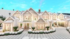 a large white house with lots of windows and snow on the ground in front of it