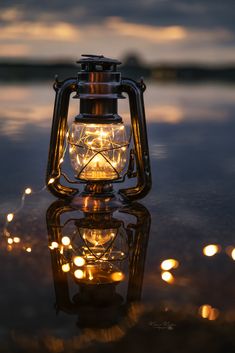 a lantern is lit up on the water