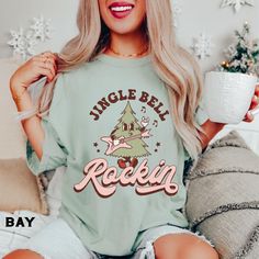 Funny Christmas Shirts for Women, Comfort Colors®, Jingle Bell Rockin Retro Christmas Holiday Tee, Matching Family, Kids Christmas Tees SIZE UP for an OVERSIZED FIT (see size chart in listing photos). Looking for more Christmas and Winter themed apparel? Check these out: https://www.etsy.com/shop/TheGraphicPeach?ref=seller-platform-mcnav§ion_id=30496778 Our shop uses direct-to-garment printing to make our products. The design ink is sprayed on, then allowed to soak into the fibers of the garment. This process yields fine quality prints and a smooth finish on the garment. COMFORT COLORS Garment-dyed t-shirt, made 100% with ring-spun cotton. The soft-washed, garment-dyed fabric brings extra coziness to your wardrobe while the relaxed fit makes it an excellent daily choice. The double-needle Funny Christmas Shirts For Women, Christmas Shirt Designs, Christmas Shirts For Women, Cute Christmas Outfits, Christmas Clothes, Christmas Outfits Women, Christmas Outfits, Sweater Vest Women, Winter Themed