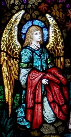 a stained glass window with an angel sitting on it's lap and holding a red blanket