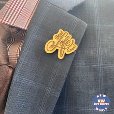 the lapel of a man wearing a suit and tie with an emblem on it