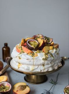 a cake with fruit on top sitting on a table