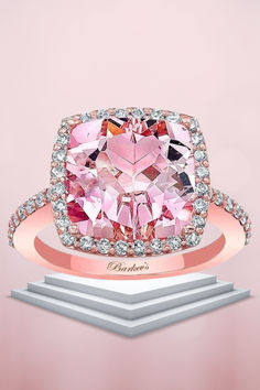 a pink diamond ring with diamonds surrounding it