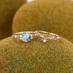 a close up of a ring on top of a mossy surface