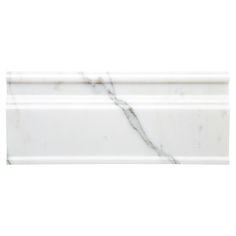 a white marble shelf with an intricate design