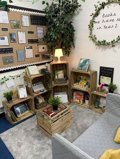 a room filled with lots of books and boxes on the floor next to a couch