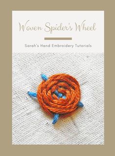 an orange and blue yarn ball on top of a white cloth with the words woven spider's wheel