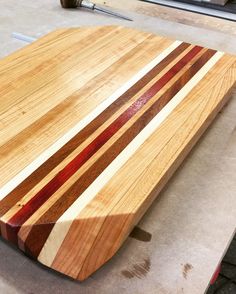 a wooden cutting board sitting on top of a table