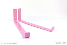 a pair of pink shelf brackets on a white background with the words pastel pink above them