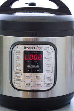 an instant pot is shown with the time displayed on its display screen and it's lid open