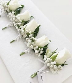 Groom – White rose with baby’s breath and greenery 
Groomsmen – Pink or Purple rose with baby’s breath and greenery (rose colour dependent on colour of bridesmaid dresses & groomsmen’s ties - colour to match). Wedding Bouquet Classic Elegant, Classic Boutonniere Wedding, Gypsophila And Rose Bouquet, White Rose Buttonhole, White Roses And Gypsophila, Wedding Button Holes, Groomsmen Pink, White Buttonhole, Buttonholes Wedding