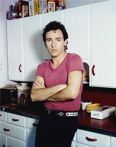 a man standing in a kitchen with his arms crossed