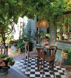 a table and chairs sitting under a tree