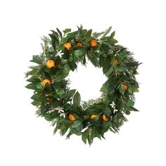 a wreath with oranges and greenery on it