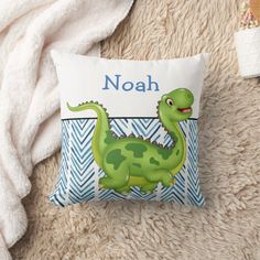 a personalized pillow with a green dinosaur on it